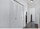 Bright hallway featuring a closet with bifold doors and access to other rooms at 201 S Greenfield Rd # 255, Mesa, AZ 85206