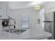 Bright kitchen with stainless steel appliances, a double sink, and updated fixtures at 201 S Greenfield Rd # 255, Mesa, AZ 85206