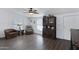 Cozy living room featuring wood-look floors, comfy seating, and a charming display cabinet at 201 S Greenfield Rd # 255, Mesa, AZ 85206