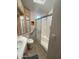 Bright bathroom featuring a shower with sliding glass doors and a beige vanity with upper and lower cabinets at 2072 W Klamath Ave, Apache Junction, AZ 85119