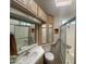 Bright bathroom with a glass-enclosed shower, vanity with mirror, and ample cabinet space at 2072 W Klamath Ave, Apache Junction, AZ 85119