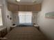 Comfortable bedroom featuring a large bed, overhead storage, and natural light from the window at 2072 W Klamath Ave, Apache Junction, AZ 85119
