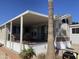 Charming home with covered porch, landscaping and clear skies at 2072 W Klamath Ave, Apache Junction, AZ 85119