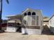 Charming single-Gathering home featuring a covered porch, multiple windows, and an extended awning with parking at 2072 W Klamath Ave, Apache Junction, AZ 85119