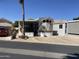 Charming single-Gathering home featuring a covered porch, multiple windows, and an extended awning with parking at 2072 W Klamath Ave, Apache Junction, AZ 85119