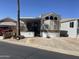 Charming single-Gathering home featuring a covered porch, multiple windows, and an extended awning with parking at 2072 W Klamath Ave, Apache Junction, AZ 85119