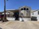 Charming single-Gathering home featuring a covered porch, multiple windows, and an extended awning with parking at 2072 W Klamath Ave, Apache Junction, AZ 85119