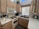 Compact kitchen with laminate counters, cabinets, and essential appliances at 2072 W Klamath Ave, Apache Junction, AZ 85119