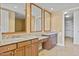 Dual sink bathroom with granite countertops, wooden cabinets, and large mirrors for a luxurious feel at 2211 E Camelback Rd # 604, Phoenix, AZ 85016