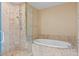Elegant bathroom featuring a glass-enclosed shower and a separate soaking tub at 2211 E Camelback Rd # 604, Phoenix, AZ 85016
