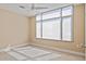 Bright bedroom features neutral walls, carpet, ceiling fan, and a large window with sun-filtering shades at 2211 E Camelback Rd # 604, Phoenix, AZ 85016