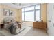 Comfortable bedroom features carpeted floors, a ceiling fan, a large window, and contemporary furnishings at 2211 E Camelback Rd # 604, Phoenix, AZ 85016