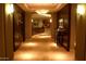 Stylish hallway with modern lighting, decorative artwork, and wood paneling at 2211 E Camelback Rd # 604, Phoenix, AZ 85016