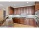 Well-equipped kitchen features dark wood cabinetry, stone countertops, and modern appliances at 2211 E Camelback Rd # 604, Phoenix, AZ 85016