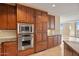 Gourmet kitchen features stainless steel appliances and custom wood cabinetry at 2211 E Camelback Rd # 604, Phoenix, AZ 85016