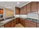 Modern kitchen with granite countertops, wood cabinets, and stainless steel appliances at 2211 E Camelback Rd # 604, Phoenix, AZ 85016