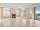 Spacious living room featuring a cozy fireplace and balcony access at 2211 E Camelback Rd # 604, Phoenix, AZ 85016