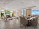 Bright living room with a fireplace, large windows, and an open dining area with contemporary decor at 2211 E Camelback Rd # 604, Phoenix, AZ 85016
