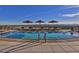 Rooftop pool featuring lounge chairs, sun umbrellas, and scenic views of the surrounding cityscape at 2211 E Camelback Rd # 604, Phoenix, AZ 85016