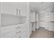 Spacious walk-in closet featuring custom white shelving, drawers, and ample hanging space for optimal organization at 2211 E Camelback Rd # 604, Phoenix, AZ 85016