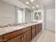 Bathroom featuring double vanity with granite countertops, dark wood cabinetry, and modern fixtures at 26930 W Renee Dr, Buckeye, AZ 85396