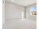 Minimalist bedroom with neutral carpet and bright window showcasing scenic mountain views at 26930 W Renee Dr, Buckeye, AZ 85396