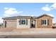 Charming single-story home featuring a stone facade, tan shutters, and a two-car garage at 26930 W Renee Dr, Buckeye, AZ 85396