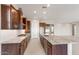 A modern kitchen boasts stainless appliances, granite countertops, and rich wood cabinetry at 26930 W Renee Dr, Buckeye, AZ 85396