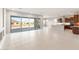 Open-concept living room with large sliding glass doors, adjacent to gourmet kitchen at 26930 W Renee Dr, Buckeye, AZ 85396