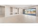 Open-concept living room with built-in shelving and large sliding glass doors at 26930 W Renee Dr, Buckeye, AZ 85396