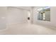 Bright living room with large window, neutral walls, and tile flooring at 26930 W Renee Dr, Buckeye, AZ 85396