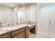 Modern bathroom with granite countertops, glass-enclosed shower, and plenty of natural light at 26942 W Renee Dr, Buckeye, AZ 85396