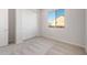 Bedroom featuring neutral carpet, a window, a closet with sliding doors and neutral paint at 26942 W Renee Dr, Buckeye, AZ 85396