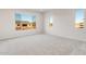 Bright, carpeted bedroom with large windows offering plenty of natural light at 26942 W Renee Dr, Buckeye, AZ 85396