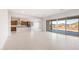 Open-concept living space with tile floors, flowing into a modern kitchen and overlooking a view at 26942 W Renee Dr, Buckeye, AZ 85396