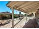 The private backyard features a covered patio, hardscape, and a view of the sparkling pool at 2717 W Medina Ave, Mesa, AZ 85202