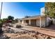 This backyard features a patio, fire pit, rocks, and mature landscaping and is perfect for relaxing and entertaining at 2717 W Medina Ave, Mesa, AZ 85202