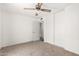 Neutral bedroom with carpet flooring, a fan, closet and a bathroom with shower at 2717 W Medina Ave, Mesa, AZ 85202