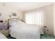 Cozy bedroom with a metal frame bed, carpet and a bright window at 2717 W Medina Ave, Mesa, AZ 85202