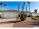 Charming single-story home featuring desert landscaping, a two-car garage, and a well-maintained facade at 2717 W Medina Ave, Mesa, AZ 85202