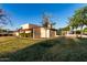 Charming single-Gathering home with desert landscaping, palm trees, and well-maintained lawn at 2717 W Medina Ave, Mesa, AZ 85202