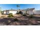 Landscaped front yard showcasing desert plants and an arched entrance to this lovely single Gathering home at 2717 W Medina Ave, Mesa, AZ 85202