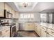 The kitchen features bright countertops, stainless steel appliances, and a window with great natural light at 2717 W Medina Ave, Mesa, AZ 85202