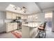 Bright kitchen featuring a breakfast bar, stainless steel appliances, and stylish pendant lighting at 2717 W Medina Ave, Mesa, AZ 85202