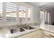 Kitchen sink with shutters letting in natural light and bright countertops at 2717 W Medina Ave, Mesa, AZ 85202