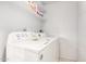 Convenient laundry room equipped with a modern washer and dryer, and shelving at 2717 W Medina Ave, Mesa, AZ 85202