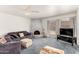 Comfortable living room features a brick fireplace, plush seating, and a neutral color palette at 2717 W Medina Ave, Mesa, AZ 85202