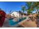 This backyard features a private pool, offering a serene escape with mature landscaping and a charming home exterior at 2717 W Medina Ave, Mesa, AZ 85202