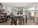 This spacious dining room has a large table with seating, a sliding glass door, and a built-in shelving unit at 3113 W Royal Palm Rd, Phoenix, AZ 85051