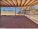 View of a covered brick patio looking out to a large grassy backyard with mature landscaping at 3702 E Karen Dr, Phoenix, AZ 85032
